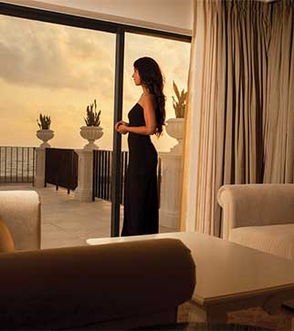 Relishing the glorious sunset & sea view from a luxury suite