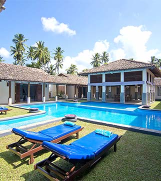 Swimming pool and with day beds at Auraliya Resort