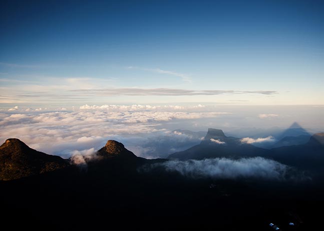 Mystic Adam's Peak soaring up above the clouds