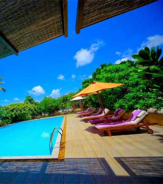 Day beds by the pool at Aditya Resort & Spa