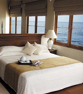 Cozy bed of sea view room at The Galle Face Hotel