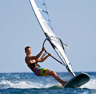 A tourist thrilled by Windsurfing in Sri Lanka