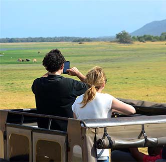 Thrilled tourists capturing scenes on a wild life tour